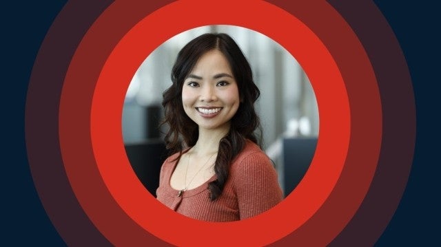 Woman smiling in an office setting.