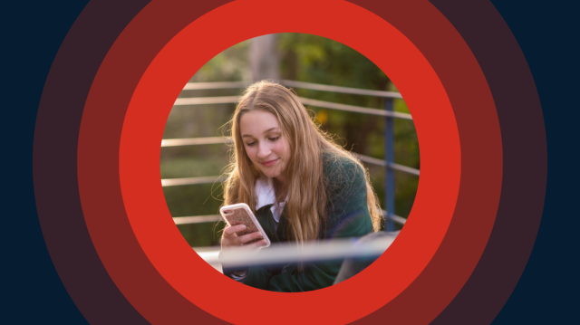 A girl sits on a bench, focused on her phone, with a thoughtful expression on her face.