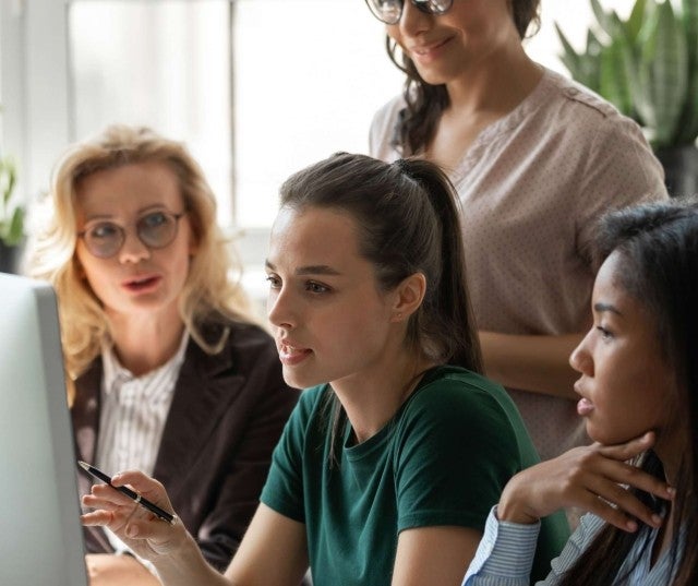 A group of educators using a computer