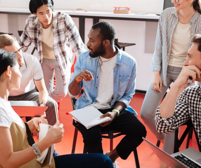 A classroom discussion between six people