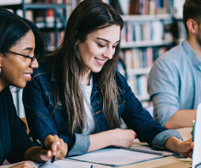 Two students study in a libarary