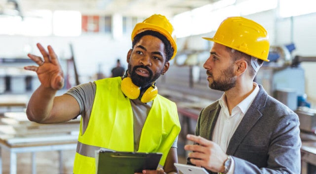 Co-workers discussing something on a job site