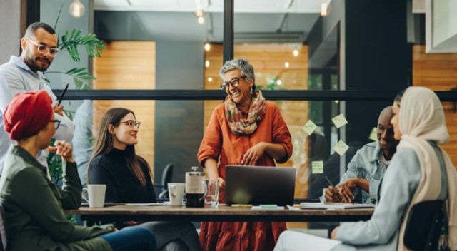 Co-workers chatting at a conference table
