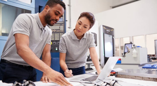 Two co-workers collaborating in a lab space